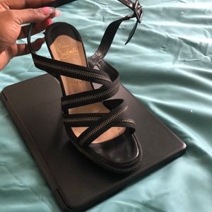 Christian Louboutin red bottoms zipper sandals.